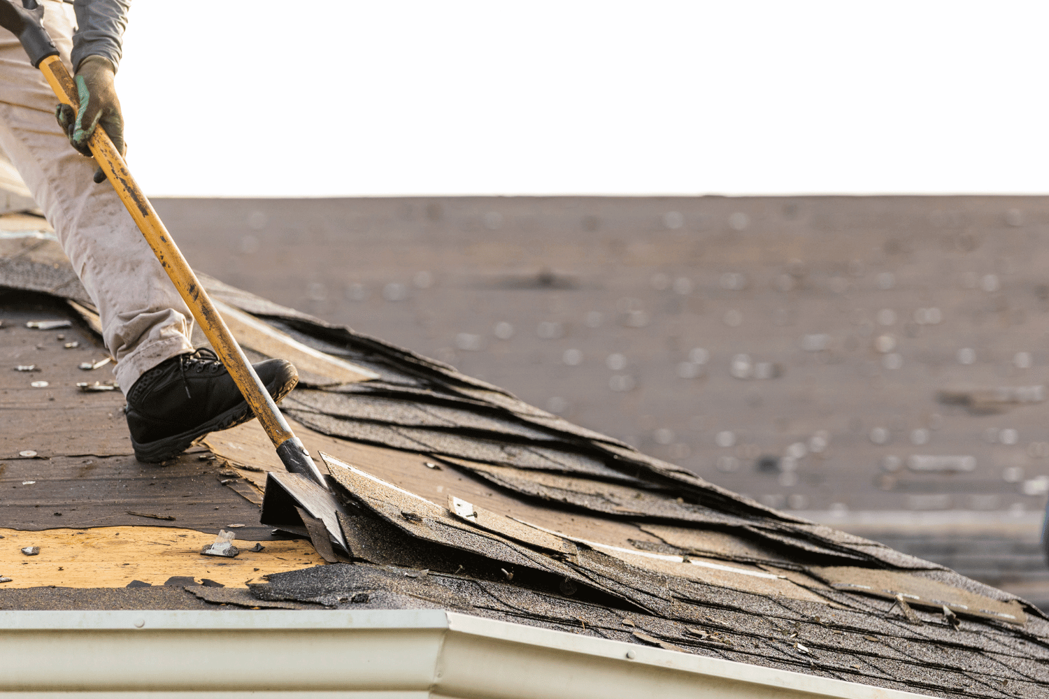 An illustration demonstrating the process of removing old shingles from a roof. 