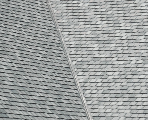 Benefits of installing new shingles over an old roof.