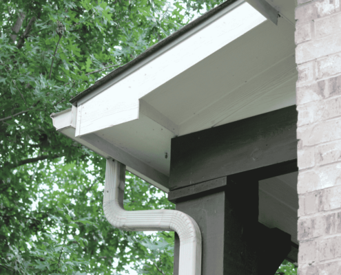 Properly secured downspouts in a gutter system.